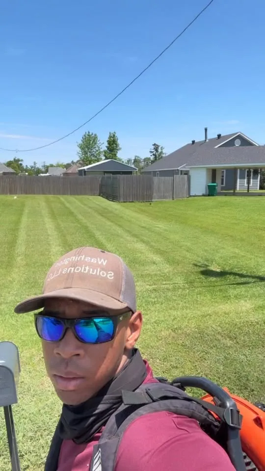 Tyler Washington on a freshly mowed lawn