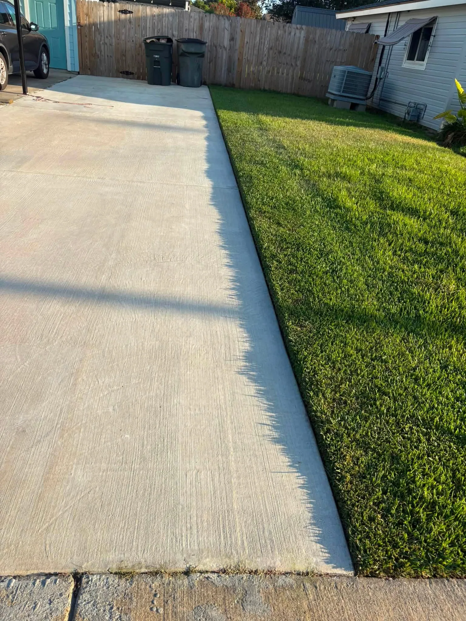 Clean lawn edge beside a residential driveway